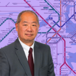 MBTA General Manager Philip Eng in a grey suit superimposed over a purple-tinted map of the MBTA subway.