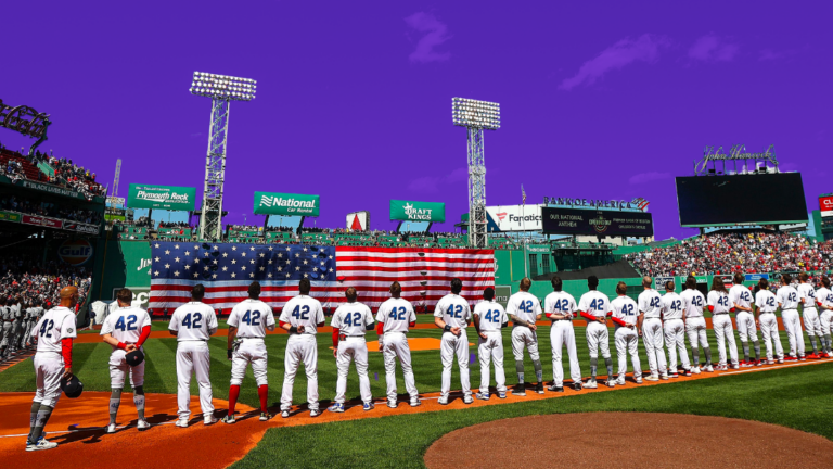 Red Sox players on Opening Day in 2022 lined up at Fenway park with a photoshopped purple sky.
