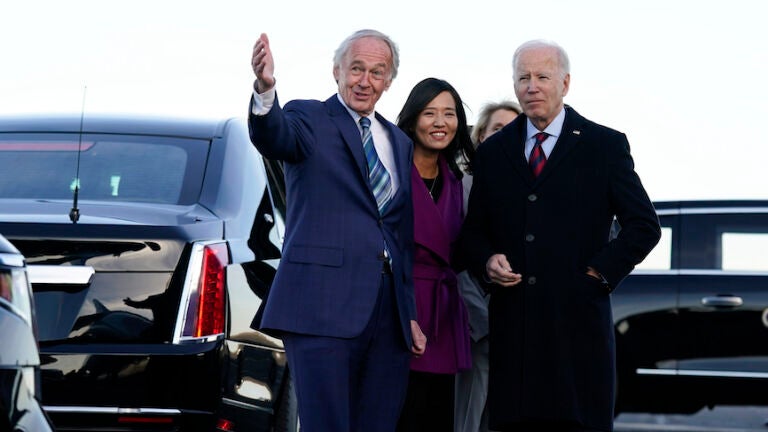 President Joe Biden is greeted by, from left, Sen. Ed Markey, Boston Mayor Michelle Wu, and Lisa Wieland, CEO of Massport, obscured, as he arrives at Boston Logan International Airport, Friday, Dec. 2, 2022.