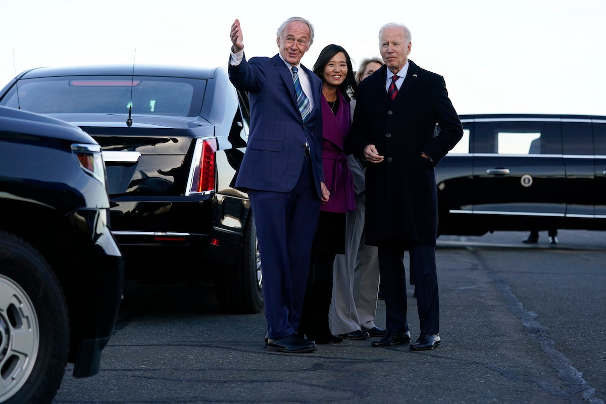 President Joe Biden is greeted by, from left, Sen. Ed Markey, Boston Mayor Michelle Wu, and Lisa Wieland, CEO of Massport, obscured, as he arrives at Boston Logan International Airport, Friday, Dec. 2, 2022.