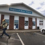 A customer walks into the Registry of Motor Vehicles office in Brockton.