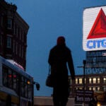 The Citgo sign is illuminated as the sun goes down in Boston.