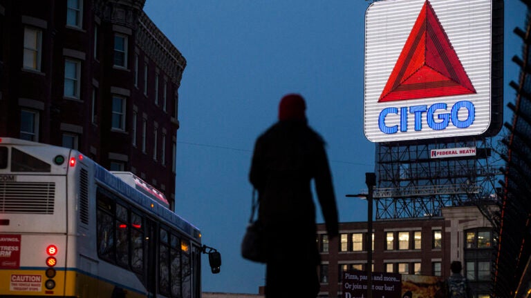The Citgo sign is illuminated as the sun goes down in Boston.