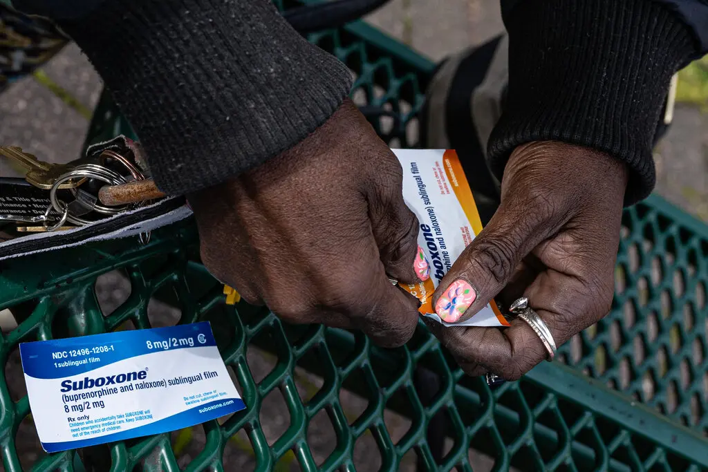 A man opens a packet of Buprenorphine 