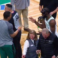 Jaylen Brown goes through a handshake line with his teammates.