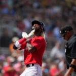 Raimel Tapia celebrates after scoring a run in spring training.