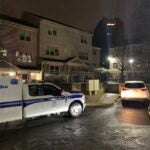 A Boston Police Department truck in front of buildings on Weaver Way