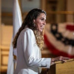 State Auditor Diana DiZoglio speaks at podium