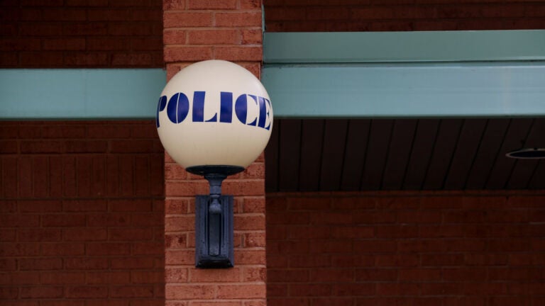 A lamp with the words "POLICE" is attached to the Stoughton Police Department headquarters