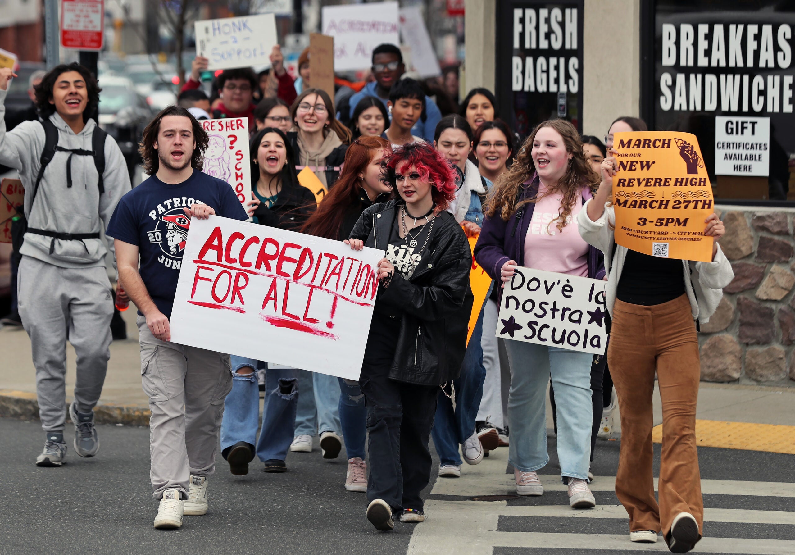 Revere High School students are pictured mid-march, holding signs in protest.
