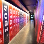 A view up the tunnel from the Red Sox dugout to the clubhouse, with championship banners painted on the walls.