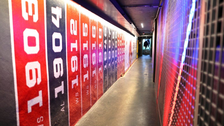 A view up the tunnel from the Red Sox dugout to the clubhouse, with championship banners painted on the walls.