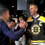 Patrice Bergeron (left) congratulates Bruins Zdeno Chara after Chara held a press conference at TD Garden to announce his retirement after he signed a one-day contract with the team to retire form the Bruins and the NHL.