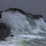 Waves crash into homes on Turner Road in Scituate.