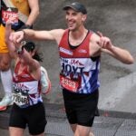Former Boston Bruins defender Zdeno Chara crosses the finish line at the 2023 Boston Marathon.