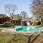 A mid-century modern ranch with an in-ground pool.