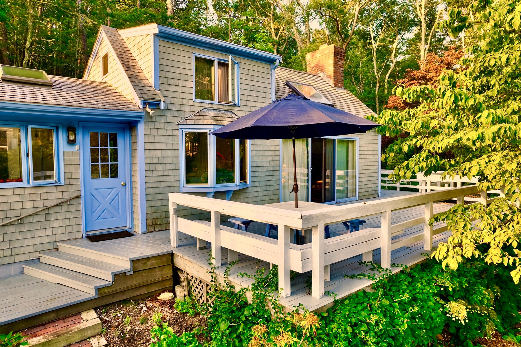 A home with cedar shake siding and robin's egg blue trim and front door.