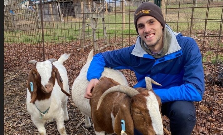 alt = Brian Bushard with a couple of goats.