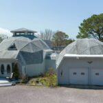 A gray home with two geodesic domes.