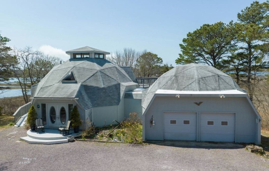 A gray home with two geodesic domes.