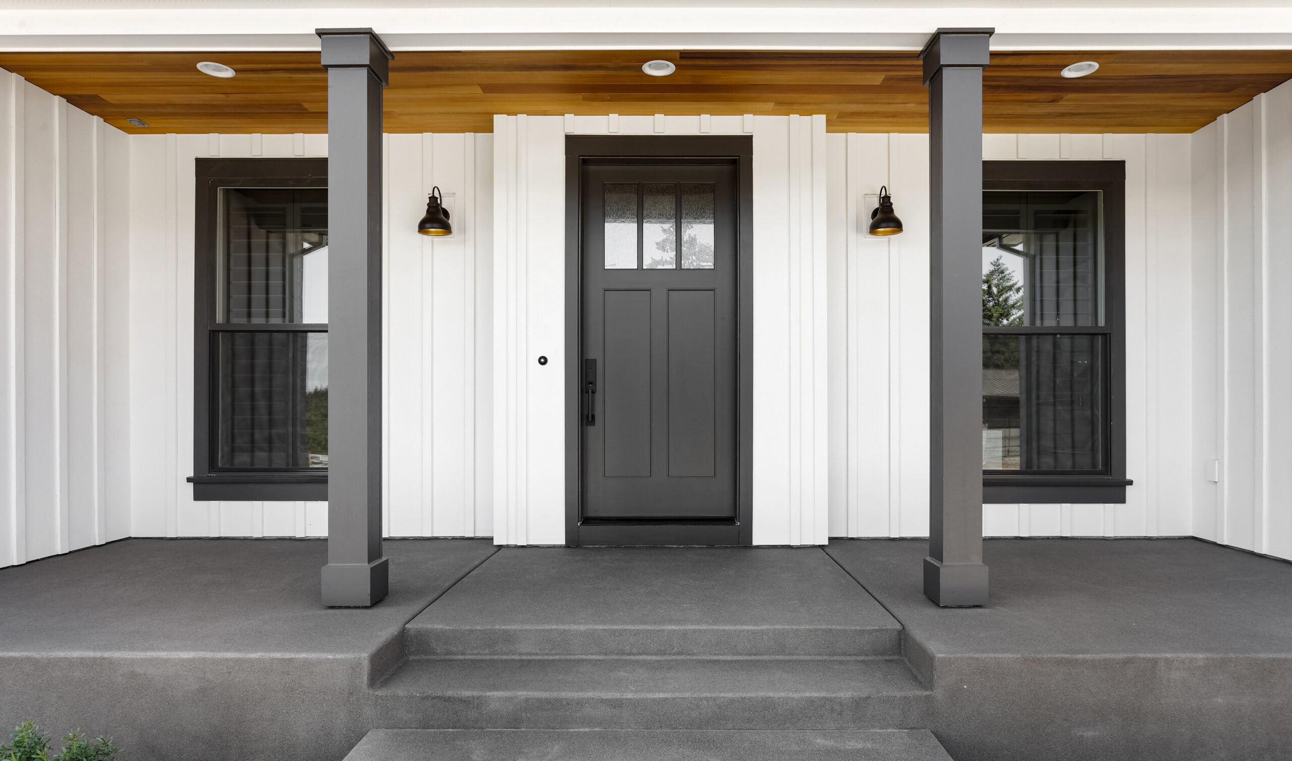 Front door to modern farmhouse home. Home exterior with white ve