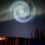 A light baby blue spiral resembling a galaxy appears amid the aurora for a few minutes in the Alaska skies near Fairbanks.