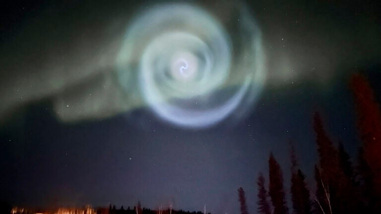 A light baby blue spiral resembling a galaxy appears amid the aurora for a few minutes in the Alaska skies near Fairbanks.