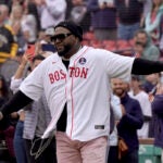 Member of the 2013 Boston Red Sox World Series championship team and Hall of Famer David Ortiz, center, steps onto the field before a baseball game between the Los Angeles Angels and the Red Sox, Sunday.