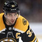Patrice Bergeron #37 of the Boston Bruins looks on during the third period against the Washington Capitals at TD Garden on April 11, 2023 in Boston, Massachusetts. The Bruins defeat the Capitals 5-2, setting the new NHL record for most points in a single season with 133.