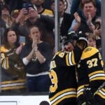 Patrice Bergeron #37 of the Boston Bruins hugs Brad Marchand #63 before exiting the ice after Florida Panthers defeat the Bruins 4-3 in overtime of Game Seven of the First Round of the 2023 Stanley Cup Playoffs at TD Garden on April 30, 2023 in Boston, Massachusetts