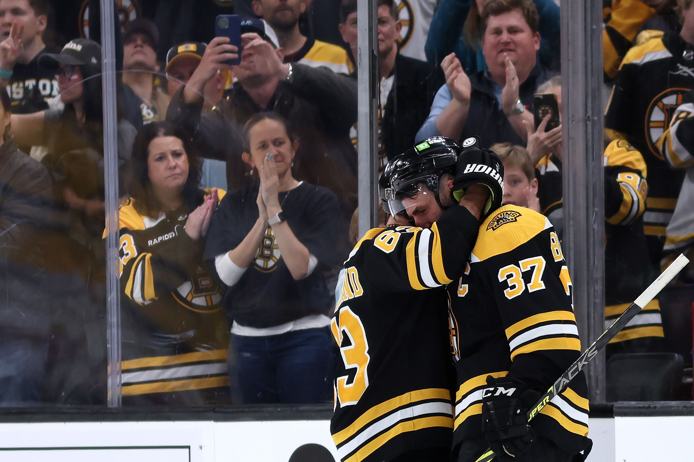 Patrice Bergeron #37 of the Boston Bruins hugs Brad Marchand #63 before exiting the ice after Florida Panthers defeat the Bruins 4-3 in overtime of Game Seven of the First Round of the 2023 Stanley Cup Playoffs at TD Garden on April 30, 2023 in Boston, Massachusetts