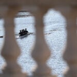 Boston weather --The setting sun warms the stone railings on the John W. Weeks Footbridge as rowers glide under on the Charles River.