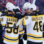 Boston Bruins' Charlie Coyle, second from right, celebrates his goal with teammates during the first period of an NHL hockey game against the Philadelphia Flyers, Sunday, April 9, 2023, in Philadelphia.
