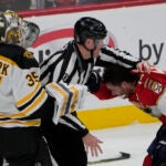 Florida Panthers left wing Matthew Tkachuk (19) his held back after exchanging punches with Boston Bruins goaltender Linus Ullmark (35) during the third period of Game 4 of an NHL hockey Stanley Cup first-round playoff series, Sunday, April 23, 2023, in Sunrise, Fla. (