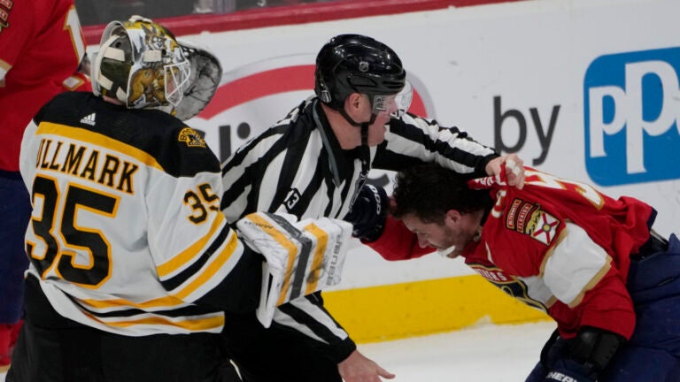 Florida Panthers left wing Matthew Tkachuk (19) his held back after exchanging punches with Boston Bruins goaltender Linus Ullmark (35) during the third period of Game 4 of an NHL hockey Stanley Cup first-round playoff series, Sunday, April 23, 2023, in Sunrise, Fla. (