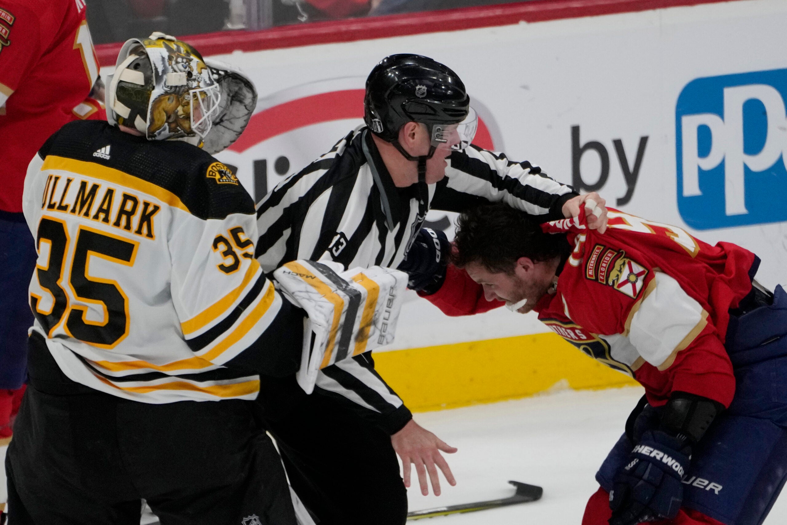 Florida Panthers left wing Matthew Tkachuk (19) his held back after exchanging punches with Boston Bruins goaltender Linus Ullmark (35) during the third period of Game 4 of an NHL hockey Stanley Cup first-round playoff series, Sunday, April 23, 2023, in Sunrise, Fla. (