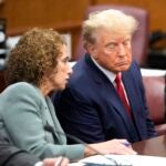 Trump - Former U.S. President Donald Trump (R) talks with one of his attorneys inside the courtroom