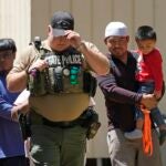 A law enforcement official works Sunday, April 30, 2023, in the neighborhood where a mass shooting occurred Friday night, in Cleveland, Texas.