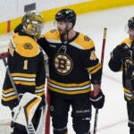 Boston Bruins goaltender Jeremy Swayman (1) celebrates with center David Krejci (46) and defenseman Connor Clifton (75) after the Bruins beat the Montreal Canadiens in an NHL hockey game, Thursday, March 23, 2023, in Boston.