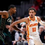 Boston Celtics guard Marcus Smart, left, defends Atlanta Hawks guard Trae Young during the second half of an NBA basketball game, Saturday, March 11, 2023, in Atlanta.