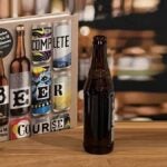 Complete Beer Course book on a bartop with a bottle of beer