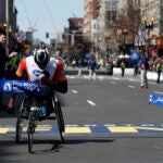 Ernst Van Dyk crosses the finish line at the 2014 Boston Marathon.