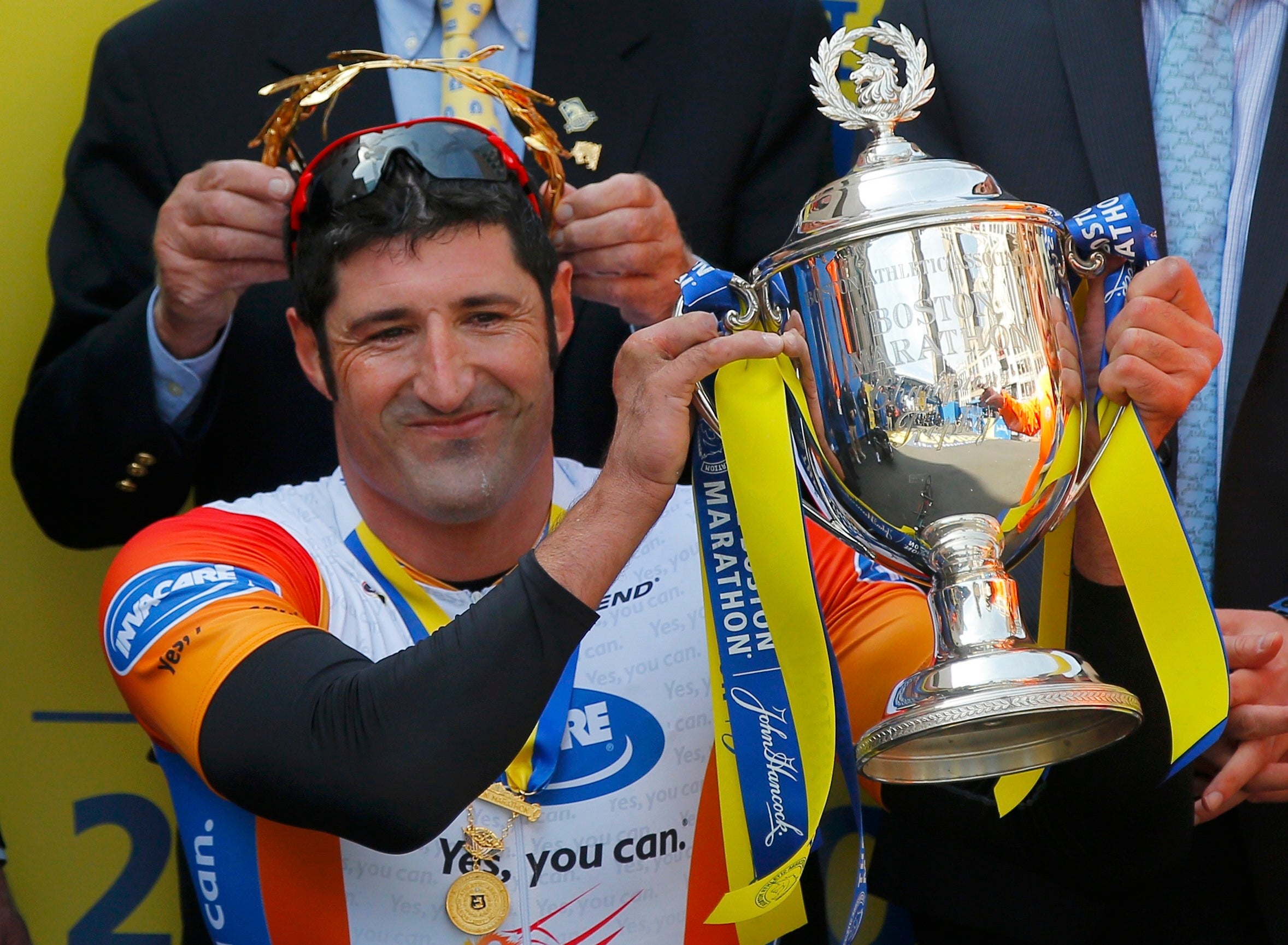 Ernst Van Dyk of South Africa holds the trophy after winning the men's wheelchair division at the 118th running of the Boston Marathon in Boston, Massachusetts April 21, 2014.