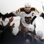 Boston Bruins' Patrice Bergeron (37) celebrates the goal by David Pastrnak (88) in overtime during an NHL hockey game against the Carolina Hurricanes, Friday, Nov. 25, 2022, in Boston.