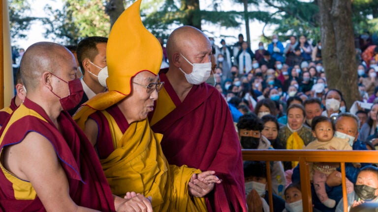 Tibetan spiritual leader the Dalai Lama in a ceremonial yellow hat arrives at the Tsuglakhang temple to give a sermon in Dharamshala, India.