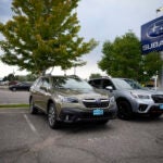 The Car Doctor: A pair of unsold 2021 sports-utility vehicles sit in an otherwise empty storage lot at a Subaru dealership in Littleton, Colo.,