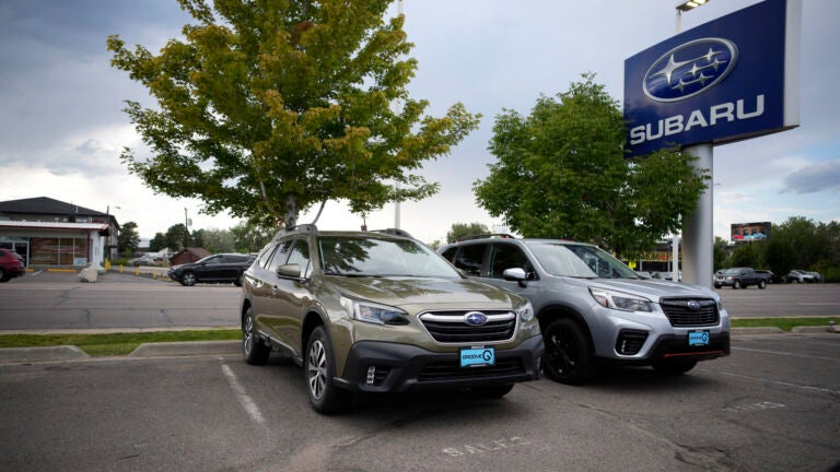 The Car Doctor: A pair of unsold 2021 sports-utility vehicles sit in an otherwise empty storage lot at a Subaru dealership in Littleton, Colo.,