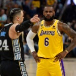 Grizzlies guard Dylan Brooks pointing away from LeBron James.