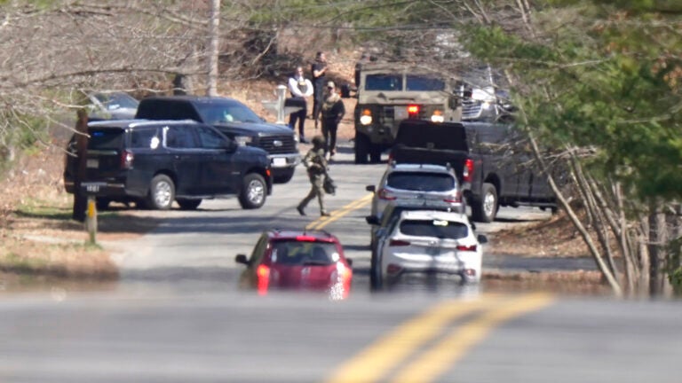 Members of law enforcement assemble on a road, Thursday, April 13, 2023, in Dighton.