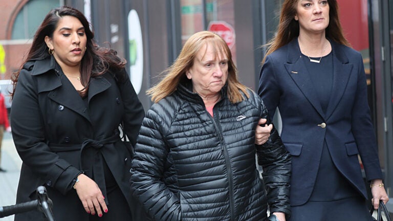 Reba Daoust (center) leaves the U.S. Courthouse.  John Joseph Moakley.  She and two others were charged with knowingly selling defective cable testing devices.